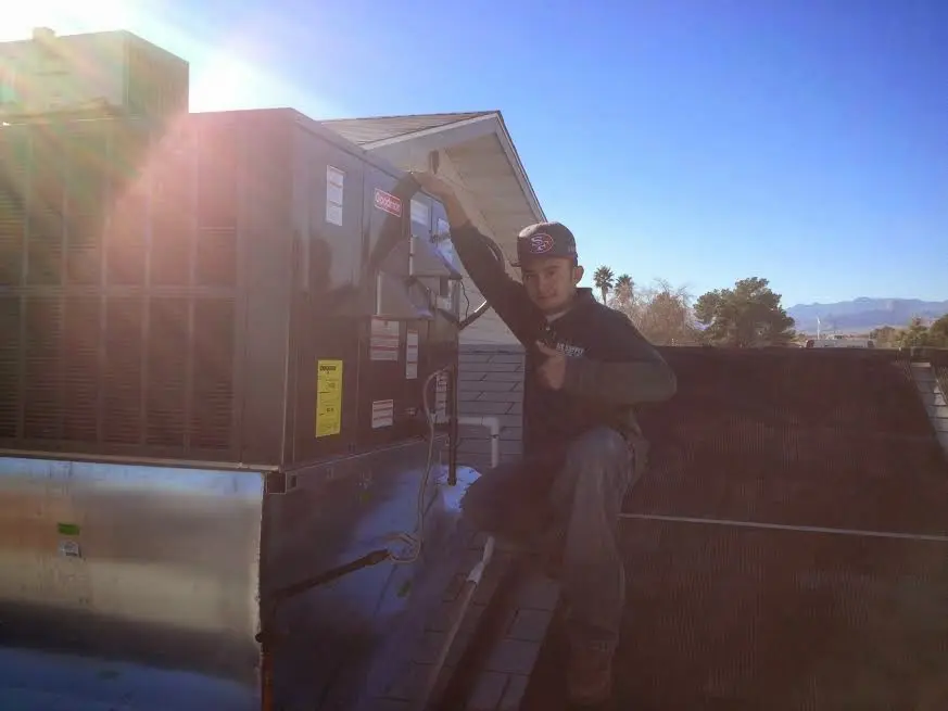 HVAC technician performing HVAC Inspection on a rooftop unit in Buffalo
